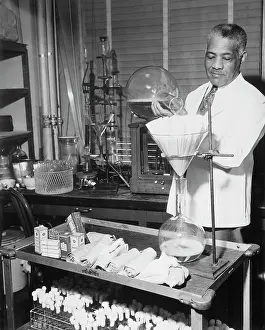 Old Fashion: A laboratory aide preparing media for testing, circa 1940's