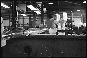 Describe: Laboratory glassware being manufactured at the