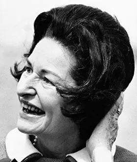Dedicate: Lady Bird Johnson smiles as the wind disrupts ?