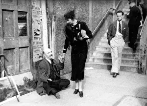 Blindness: Lady giving beggar money