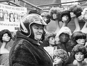 Dummies: Lady in motorcycle helmet by wig stall