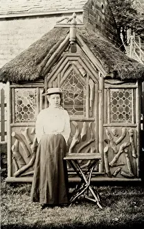 Thatched: Lady outside a rustic summer house