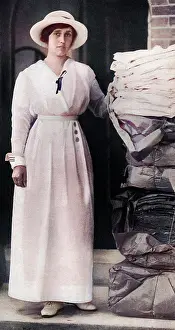 Woodbridge: Lady Quilter with pile of comforts for troops, WW1