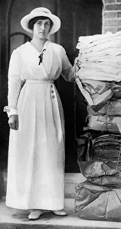 Woodbridge: Lady Quilter with pile of comforts for troops, WW1