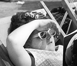 Curls: Lady wearing rollers sunbathing - Blackpool