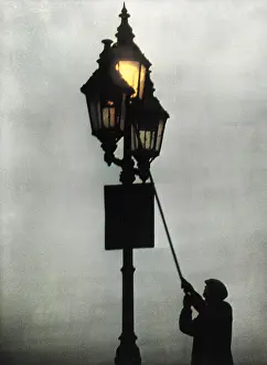 Professions: A lamplighter at work in the London fog