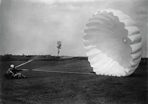 Parachutist: Landing of a parachutist. About 1930