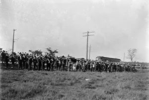 Dayton: Large crowd of spectators gathered at the edge of a field at
