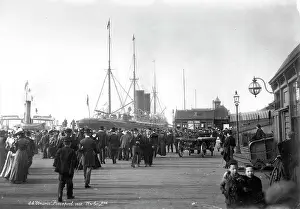 Pierhead: A large group of people converge towards the steam