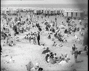 Cabins: Large Group Sitting and Standing on the Beach
