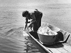Housekeeping: Laundry washing at a river, 1940