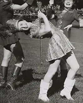 Batons: Lead majorette, doing a back bend while holding