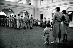 Afrikaans: Learning young... toy pistol in hand, a child