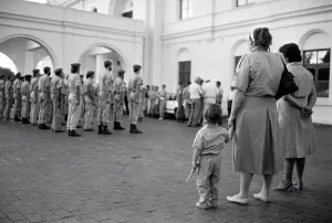 Afrikaans: Learning young... toy pistol in hand, a child