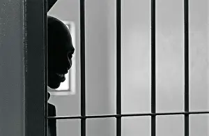 Incarcerated: A Leeuwkop prisoner looking through the prison bars