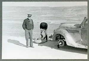 Crome: Len Crome and His Driver Edenhoffer Chaning a Wheel
