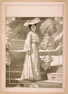 C1909: Full length image of woman, standing on steps, wearing hat a