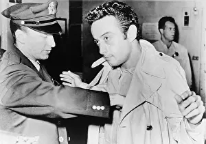 Obscene: Lenny Bruce (1925-1966), being searched ?