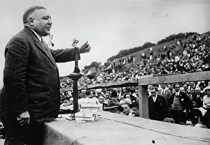Infront: LEon Dauted giving a speech