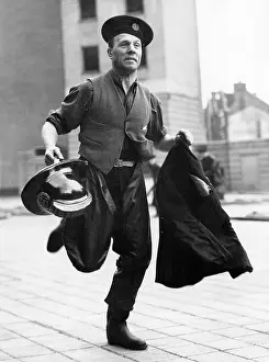 Waterproofs: LFB firefighter in a hurry, with coat and helmet