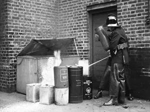 Extinguishing: LFB firefighters extinguishing oil can fire