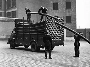 Piping: LFB firefighters unloading piping from a vehicle