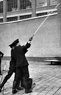 Squirt: LFB firefighters using a hand squirt
