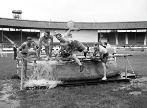 LFB firefighters in water dip, obstacle race