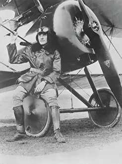 Propeller: Lieutenant Earl Carroll seated on the wheel