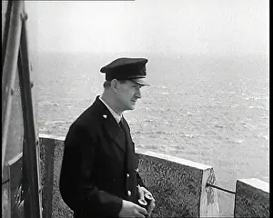 Turbulent: Lighthouse Keeper Looking Through Binoculars