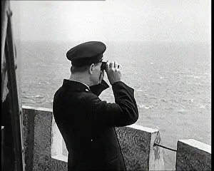 Turbulent: Lighthouse Keeper Looking Through Binoculars