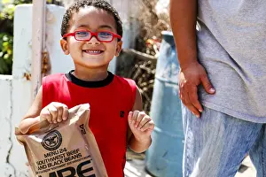 Hurricanes: A little boy with army rations distributed in San