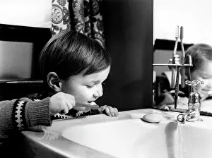 Washbasin: Little boy brushing his teeth