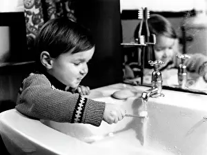 Washbasin: Little boy brushing his teeth
