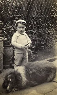 Tubs: Little boy with large dog in a garden
