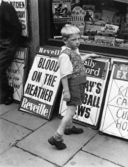 Reveille: Little boy outside an Edinburgh shop
