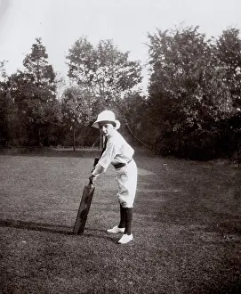 Practising: Little boy practising cricket in garden, Ealing, West London