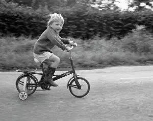 Stabilisers: Little boy riding bicycle with stabilisers