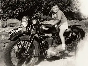 500cc: Little boy sat on 1930s Triumph motorcycle, circa 1940