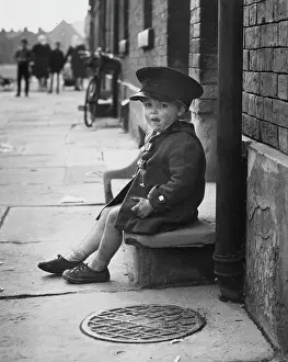 Doorstep: Little boy sitting on a doorstep