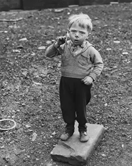 Wasteland: Little boy standing on waste ground