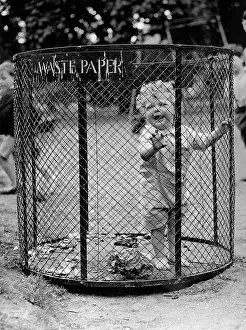 Wastepaper: A little boy in a wastepaper basket