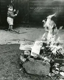 Trowel: Little boy watching a bonfire