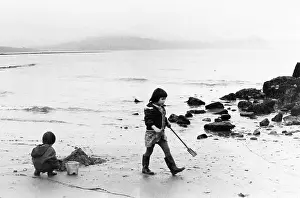 Wellies: Little girl and boy playing on the beach