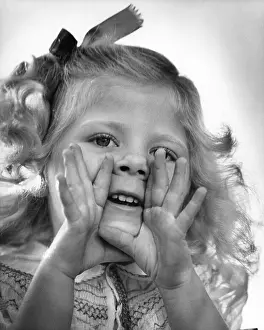 Cupped: Little girl hands to face calling out