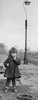 Junk: Little girl on a muddy pavement