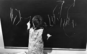 Sixtiesroger: Little girl writing on a blackboard
