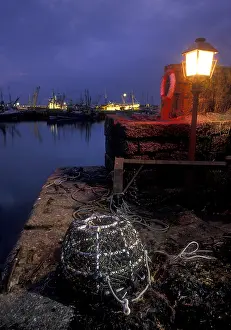 Lobster: Lobster pot lit by harbour light at night, Newlyn, Cornwall