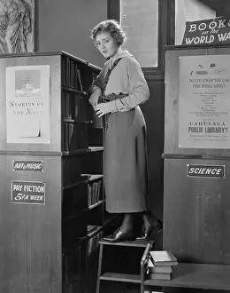 Librarian: Local librarian stocking books in library