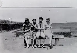 Golfing: Four local people on a golf course in the Far East